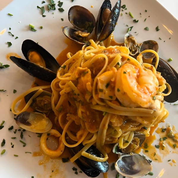 Pizzeria Vivoli's seafood linguine with mussels, clams, shrimp, and squid in a rich orange sauce.